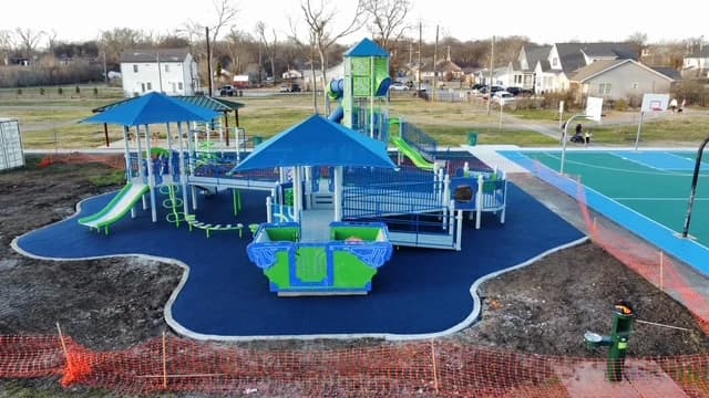 Custom poured rubber surfacing around a colorful playground