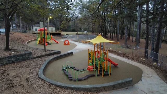 Curving paths connecting poured rubber play areas