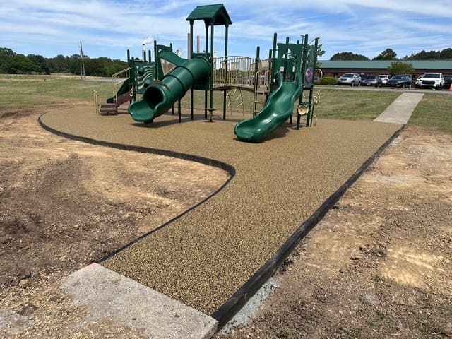 Finished tan rubber surfacing at a North Georgia playground